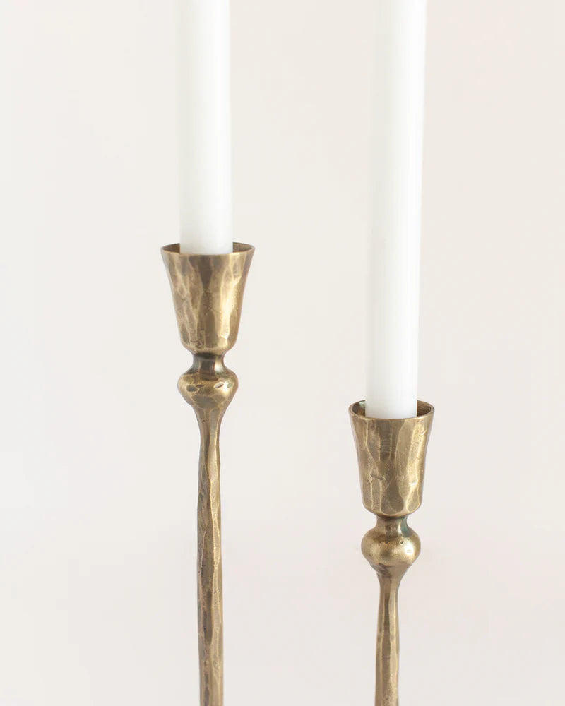 Set of two Gemini hand-forged iron candelabras with brass finish, decorative candlestands for elegant candle display.