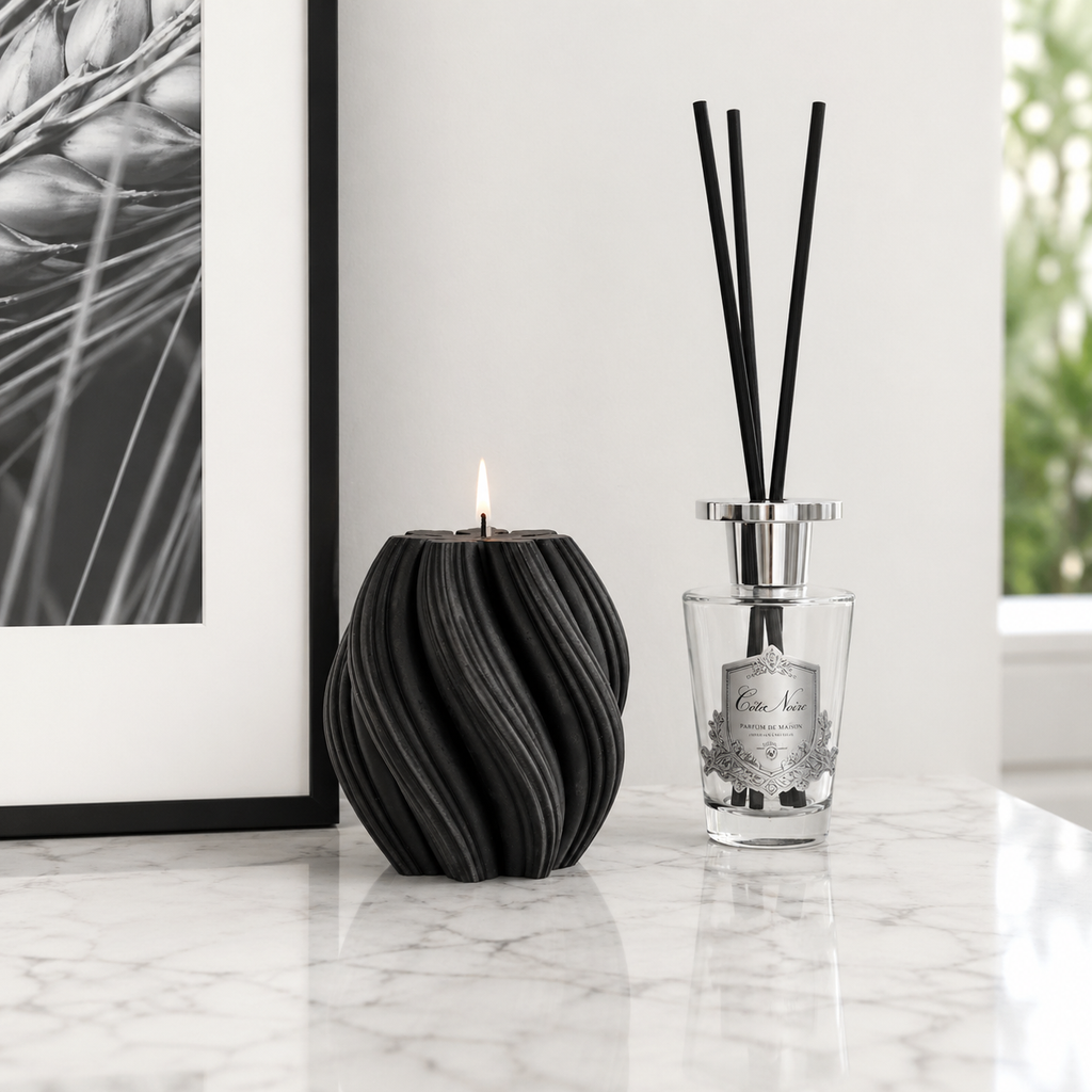 Black cranberry swirl candle by Escape to Paradise, showing a decorative candle with a swirling design and black and cranberry colors.